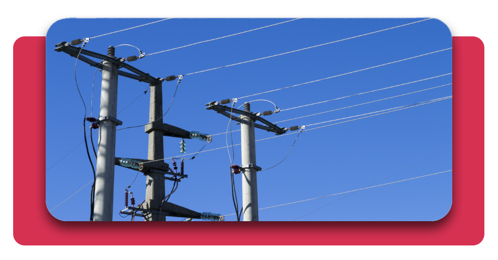 Redes de transmisión eléctrica de baja tensión en un fondo azul claro de cielo despejado. Postes de distribución y recepción de energía eléctrica